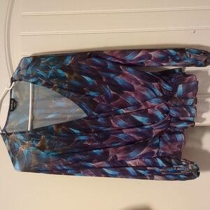 Ladies BeBe size L sheer long sleeve blouse with ruffles on bottom